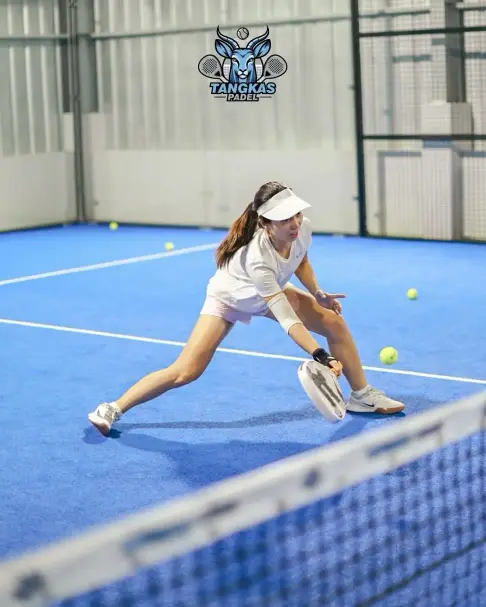 A player lunging for a low ball